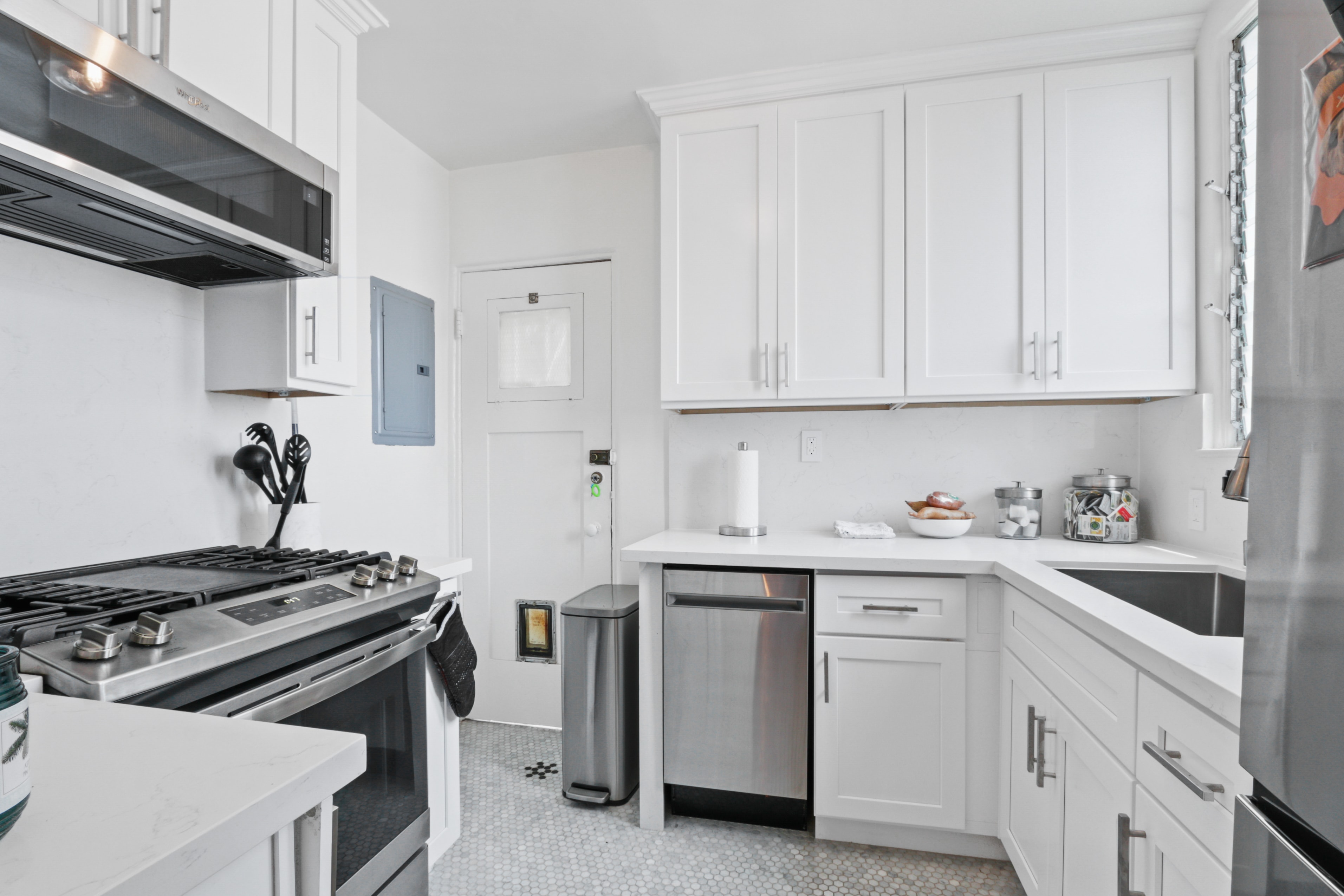 Modern kitchen with white cabinetry and stainless appliances
