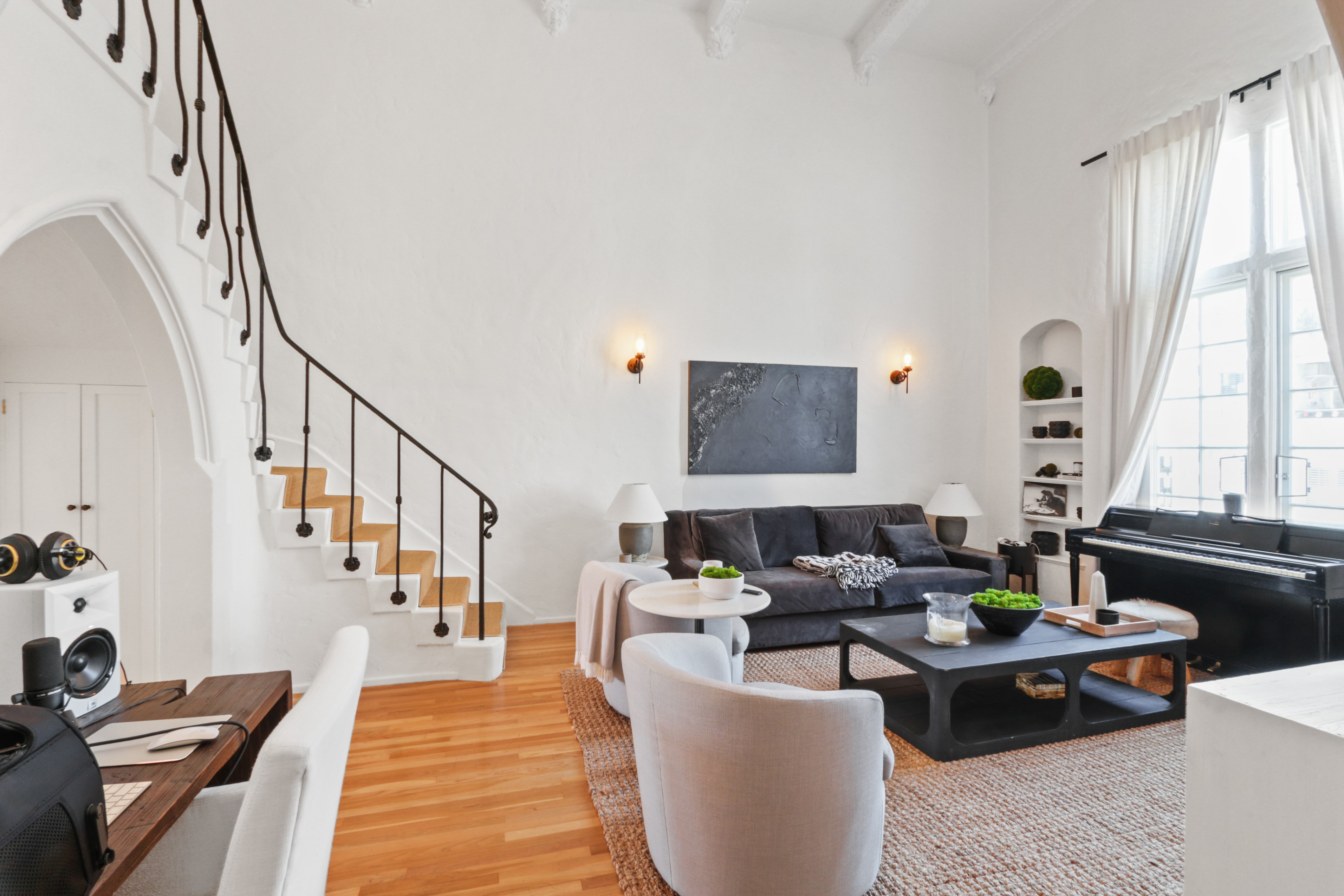 Dramatic living room with iron staircase and double-height ceilings